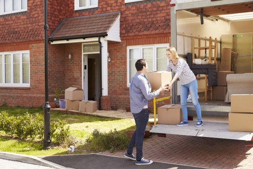 Professional removals crew loading items safely into a van