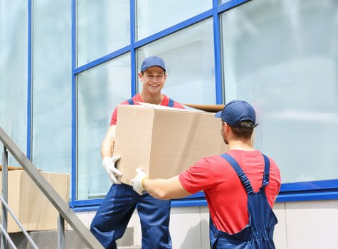 Removal team using safe lifting practices during a house move
