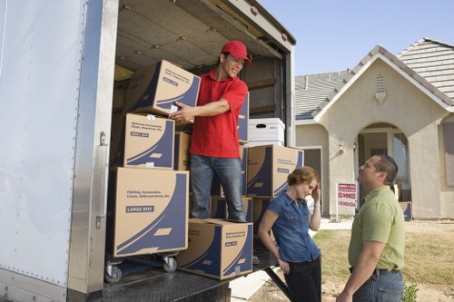 Moving crew handling packed household items carefully