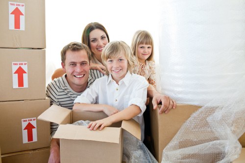 Professional movers carrying furniture during a Richmond upon Thames flat removal